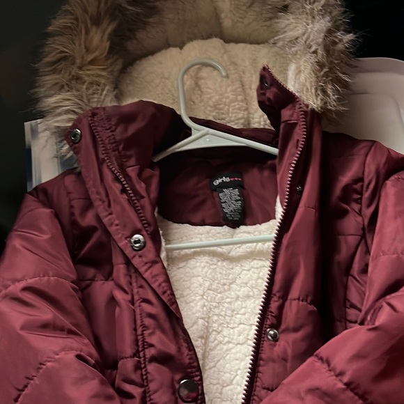 Long girls coat for winter . Maroon in color. Zips up warm fleece interior - Picture 1 of 3